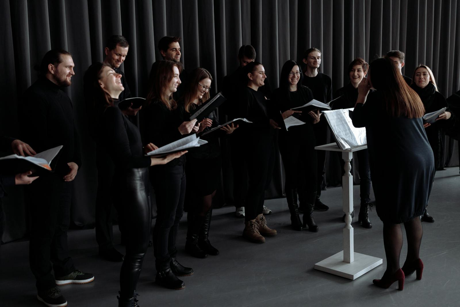 Group of People Standing in Front of a Conductor